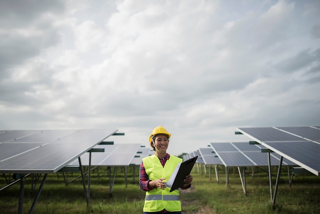 Engineer electric woman checking and maintenance of solar cells.