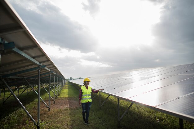 Engineer electric woman checking and maintenance of solar cells.