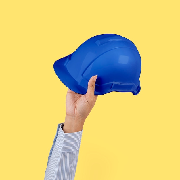 Free photo engineer hard hat held by a hand jobs and career campaign