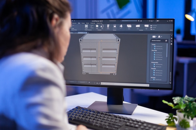 Free photo engineer looking at cad software 3d prototype design concept of container working overtime in construction company