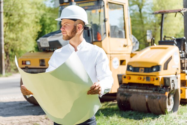 premium-photo-engineer-near-road-machinery-the-concept-of-building-a