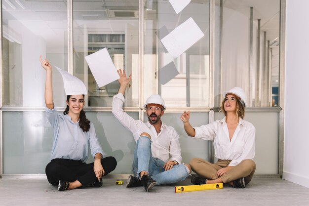 Engineers throwing papers in air