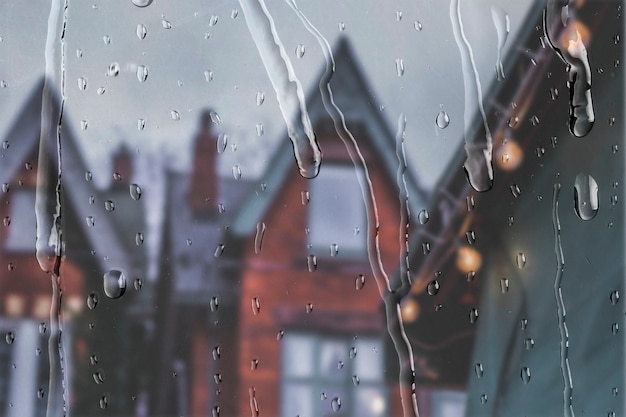 English apartments view through window with rain drops