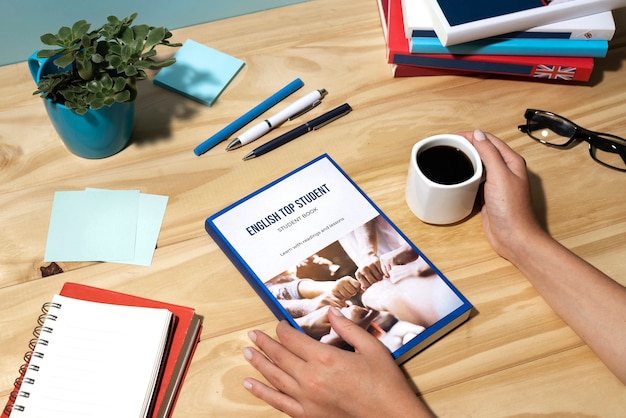 Free photo english book resting on the table of working space