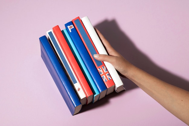 English books resting on the table of working space