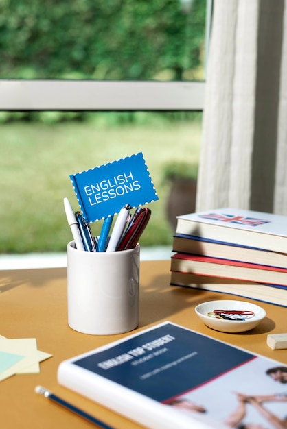 English books resting on the table of working space