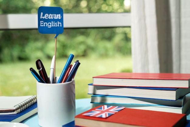 Free photo english books resting on the table of working space