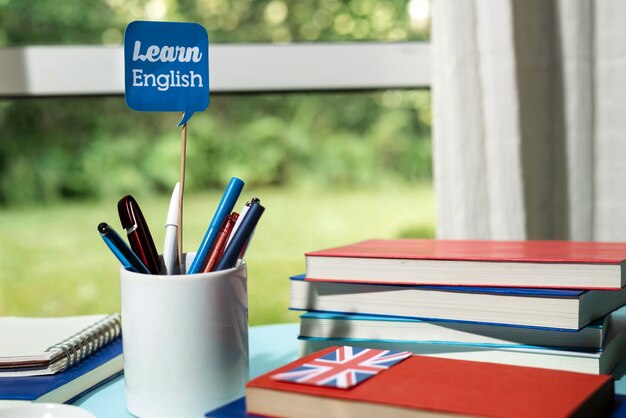 English books resting on the table of working space