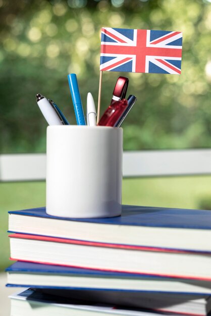 English books resting on the table of working space