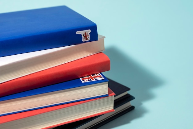 English books stacks on table of working space