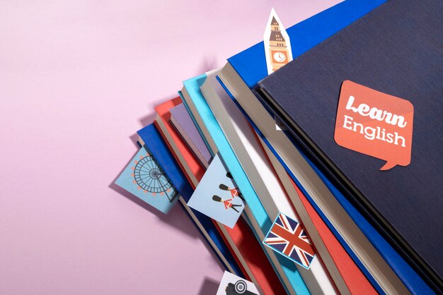 English books stacks on table of working space