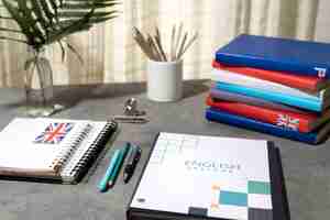 Free photo english books stacks on table of working space