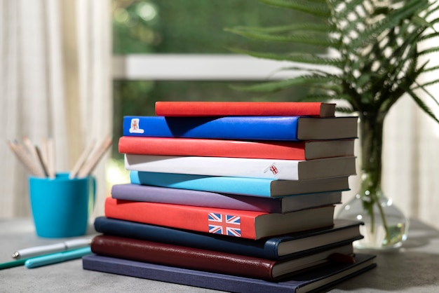 Free photo english books stacks on table of working space