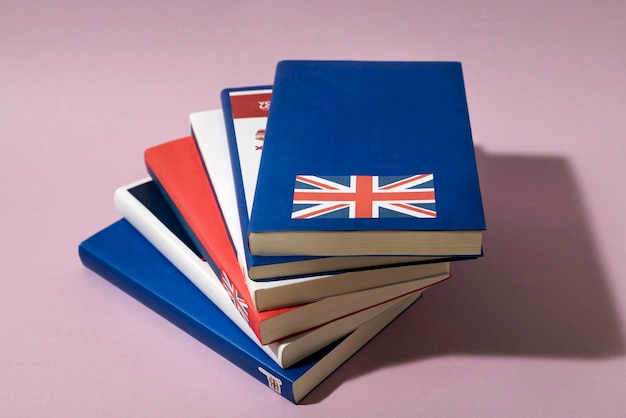 Free photo english books stacks on table of working space