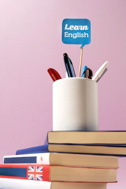 Free photo english books stacks on table of working space