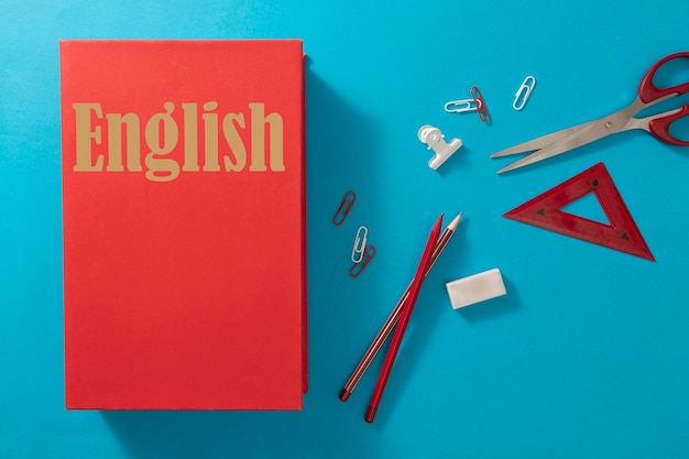 Free photo english dictionary and pencils above view