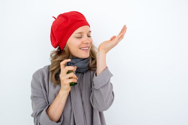 Enjoyable French woman smelling perfume