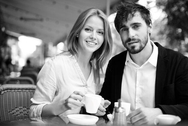 Enjoying fresh coffee together in black and white