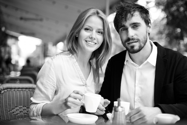 Enjoying fresh coffee together in black and white