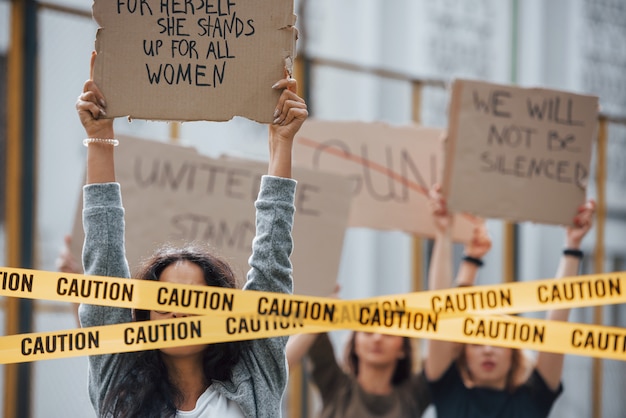 Enjoying during protest. Group of feminist women have riot for their rights outdoors