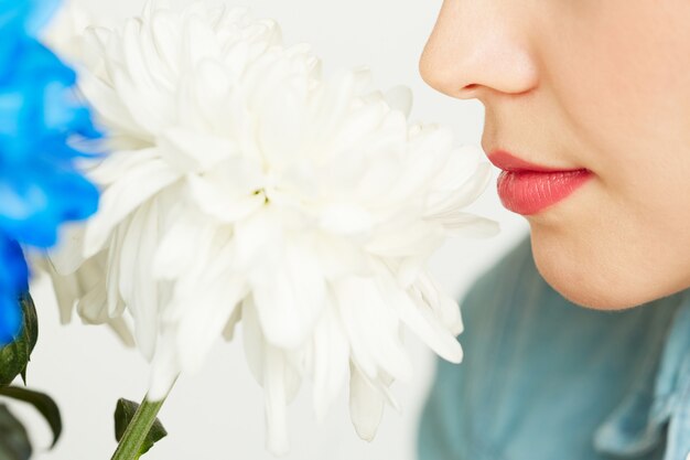 Enjoying smell of white chrysanthemum