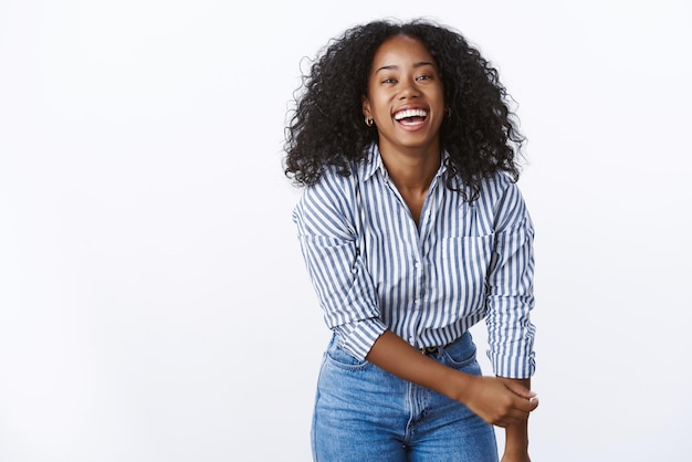 Free photo entertained charming african american woman bending towards camera having fun