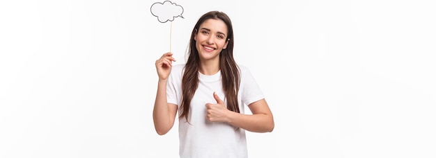 Entertainment fun and holidays concept portrait of satisfied cute young girl with long hair holding