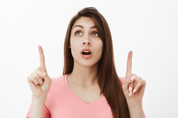 enthusiastic charming brunette woman posing in the studio