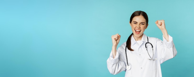 Free Photo enthusiastic doctor woman rejoicing winning and celebrating achieve goal standing in white coat agai
