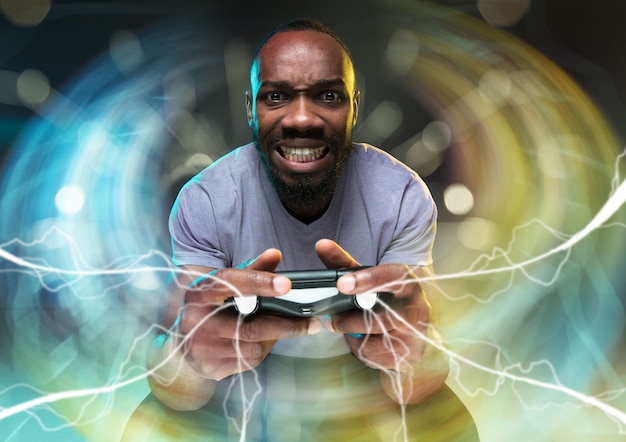 Enthusiastic gamer. Joyful young man holding a video game controller