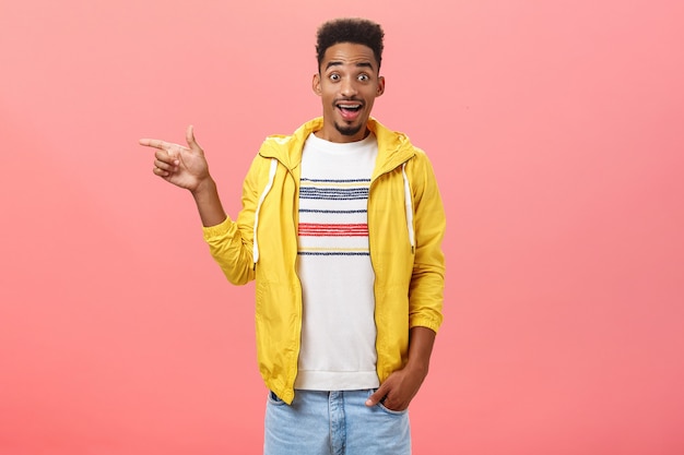 Enthusiastic goodlooking african american young man with beard seing awesome car of friend wanting t...