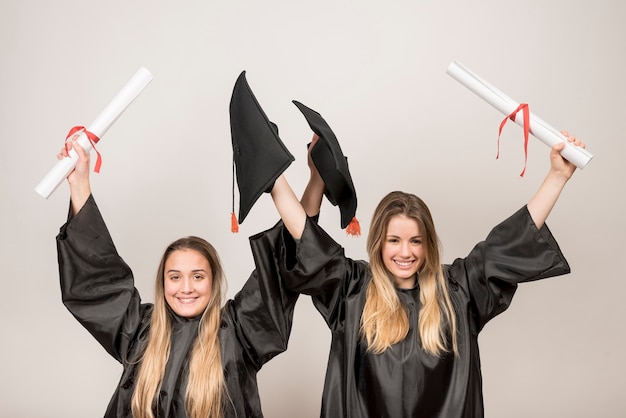 Free photo enthusiastic graduates looking at the camera