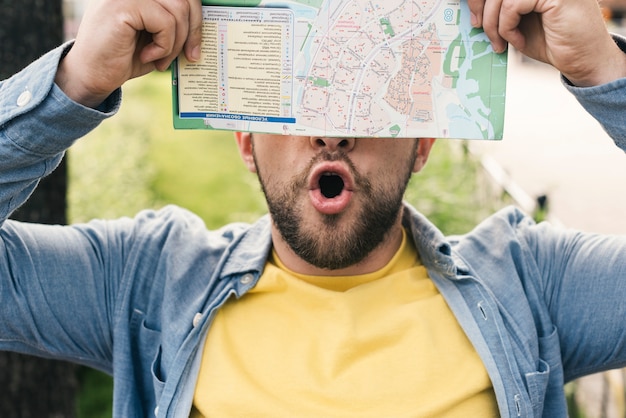 Enthusiastic man holding a map