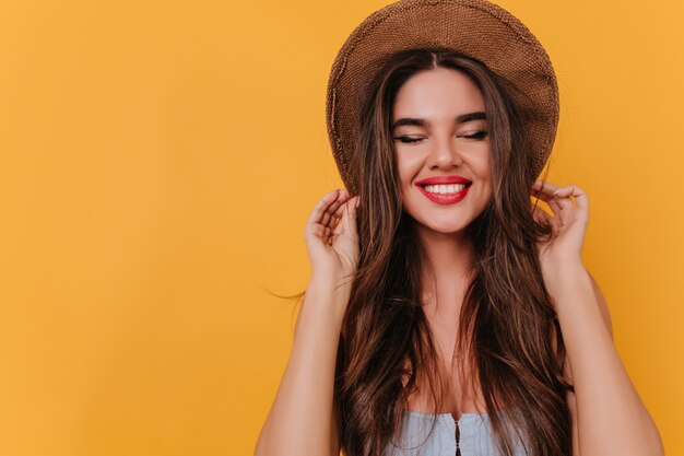 Enthusiastic white girl with long dark-brown hair posing with cute smile