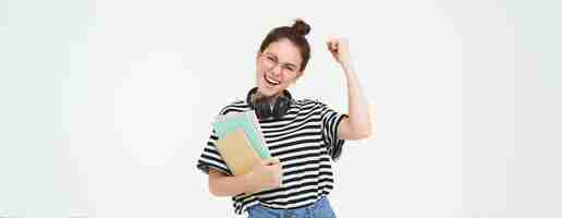 Free photo enthusiastic young woman in glasses teacher celebrating raising hand up and cheering tirumphing with