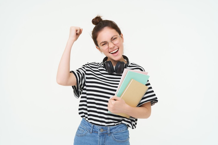 Free Photo enthusiastic young woman in glasses teacher celebrating raising hand up and cheering tirumphing with