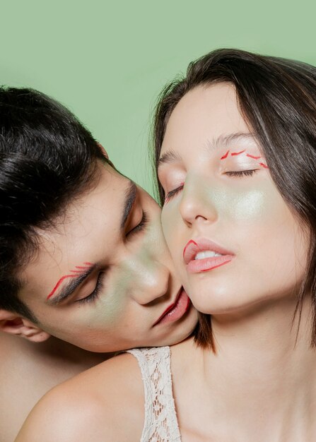 Enticing couple posing with painted faces