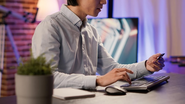 Entrepreneur doing online shopping with credit card on computer, making discount purchase with banking transaction. Buying from retail store website to order on sale, electronic currency.