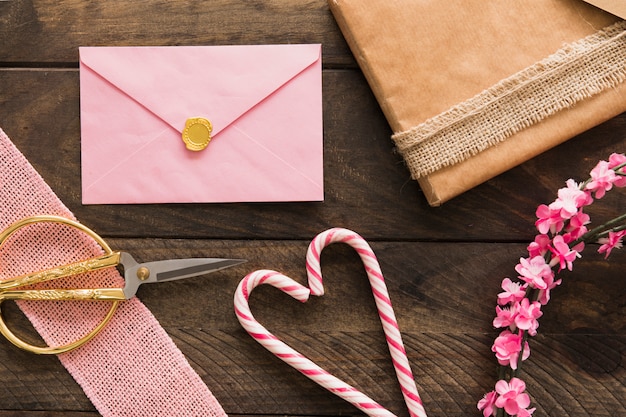 Envelope, candy canes, present and twigs with flowers