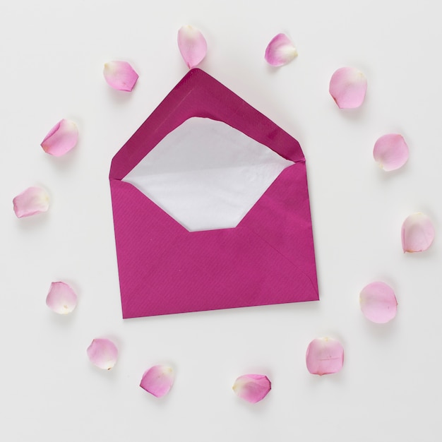 Free photo envelope between set of fresh rose petals in form of circle