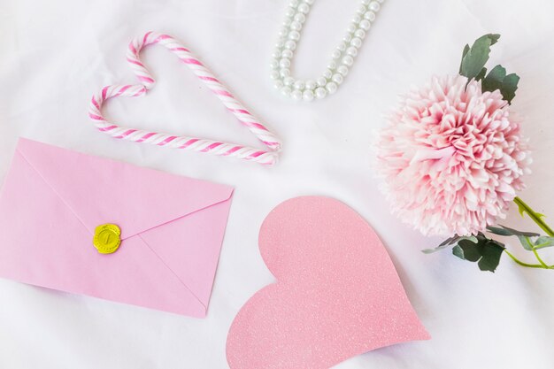 Envelope with big pink paper heart on table