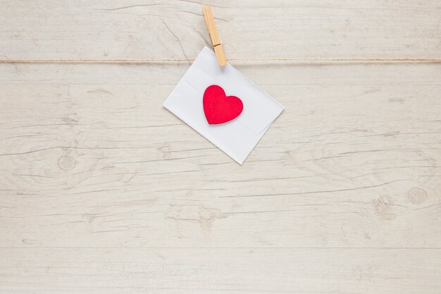 Envelope with heart hanging on rope