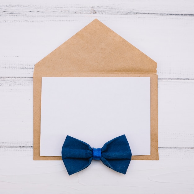 Envelope with paper and bow tie