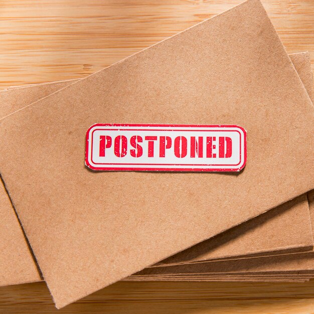 Envelope with postponed message on desk