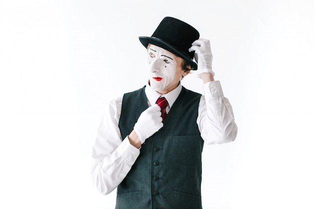 Envious mime fixes his hat