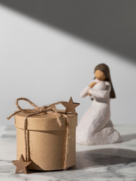 Free photo epiphany day female figurine with baby and gift box