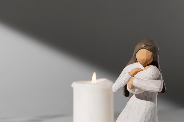 Epiphany day female figurine with newborn and candle