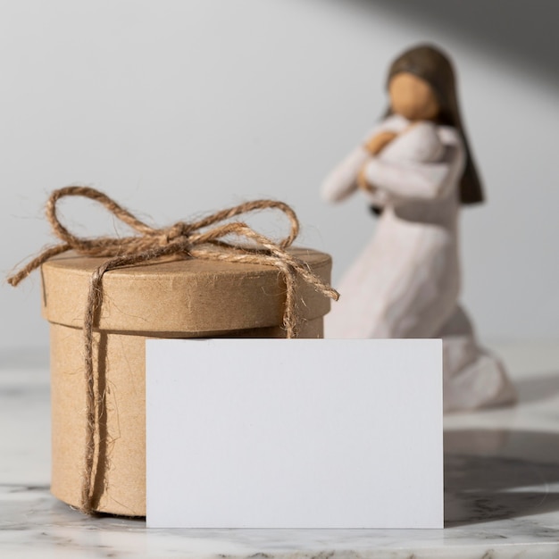 Epiphany day female figurine with newborn and gift box