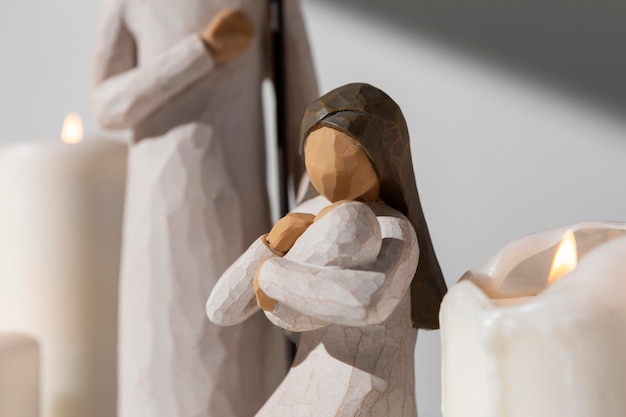 Free photo epiphany day female and male figurine with baby and candles