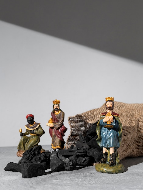 Epiphany day kings figurines with sack of coal and copy space